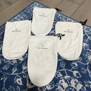 Four pairs of white Allen Edmonds shoe bags.